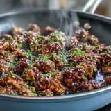 A skillet of Korean-Style Ground Turkey served alongside fluffy steamed white rice and fresh broccoli.