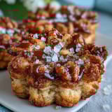 Flower-shaped shortbread cookies with golden edges, delicate and buttery, perfect for spring tea parties.