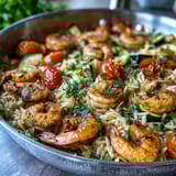Creamy lemon butter shrimp and orzo dish featuring tender shrimp, orzo pasta, and bright vegetables, perfect for a quick dinner.  