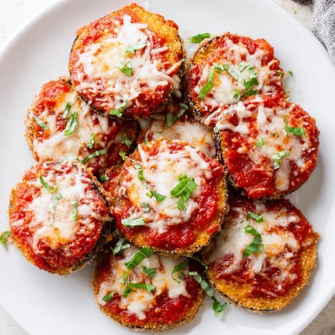 Golden, bubbly Eggplant Parmesan, a delicious Italian casserole with melted cheese.