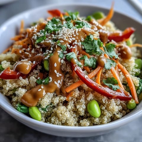 A vibrant Thai Coconut Quinoa Bowl topped with crisp vegetables and fresh cilantro for a healthy meal.