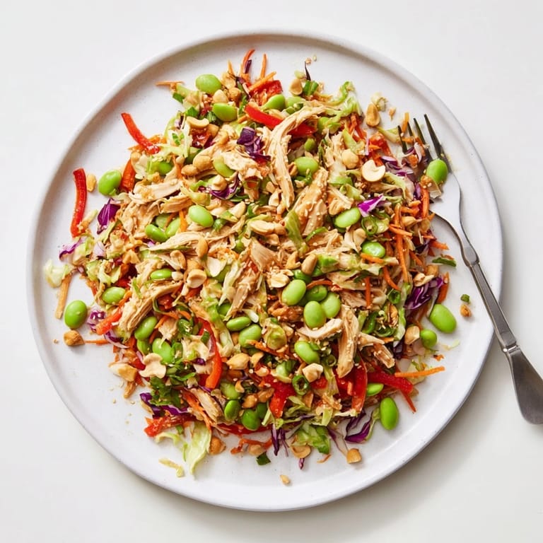 A refreshing Edamame Crunch Chicken Salad with edamame, cashews, and a spicy ginger-lime dressing, ideal for lunch.