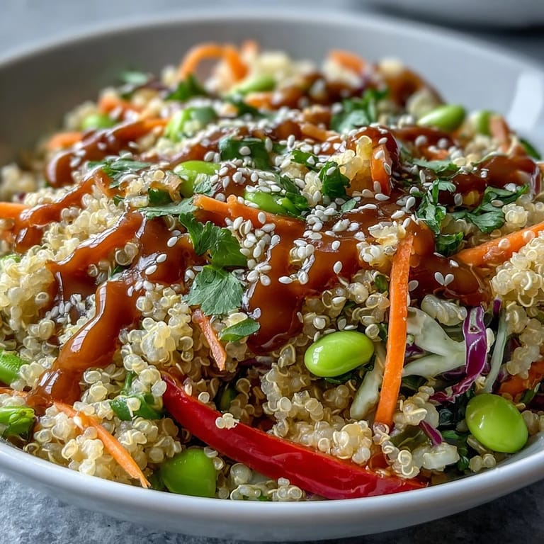 A drizzle of creamy peanut dressing coats this nourishing Thai Coconut Quinoa Bowl for a savory finish.