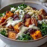 Bright roasted sweet potatoes and massaged kale shine in this Harvest Kale Quinoa Bowl, drizzled with creamy lemon tahini dressing.